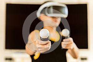 Teenager boy playing game with Virtual reality headset with goggles.