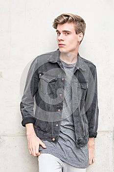 Teenager boy portrait posing over concrete background