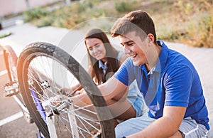 Teenager boy repair tire on bicycle