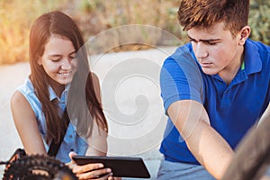 Teenager boy repair tire on bicycle