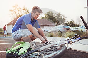 Teenager boy repair tire on bicycle