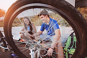 Teenager boy repair tire on bicycle