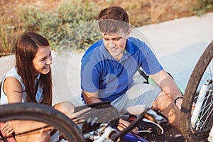 Teenager boy repair tire on bicycle