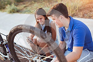 Teenager boy repair tire on bicycle