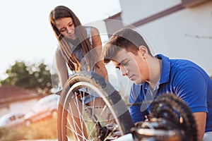 Teenager boy repair tire on bicycle