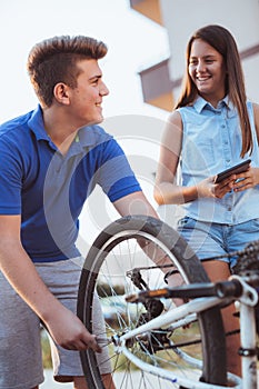 Teenager boy repair tire on bicycle