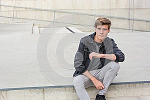 Teenager boy sitting on stairs thoughtful about choices