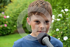 Teenager boy speaking at the microphone