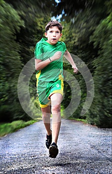 Teenager boy in sportswear run on the country road