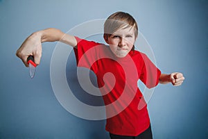 Teenager boy twelve years in the red t-shirt with