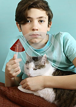 Teenager boy with water melon shape sugar candy on stick