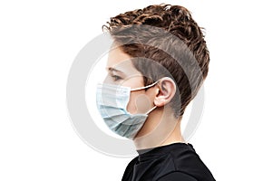 Teenager boy wearing respiratory protective medical mask side view