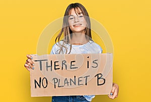 Teenager caucasian girl holding there is no planet b banner looking positive and happy standing and smiling with a confident smile