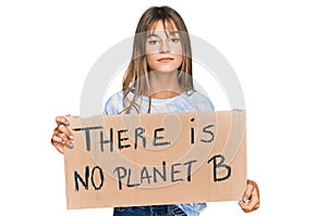 Teenager caucasian girl holding there is no planet b banner thinking attitude and sober expression looking self confident