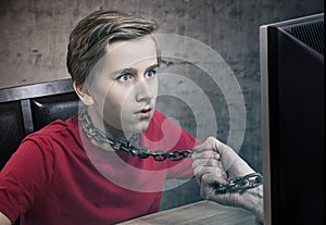 Teenager chained to his computer.