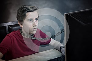 Teenager chained to his computer.