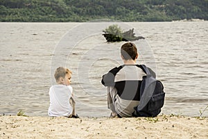 A teenager and a child dreaming on the banks