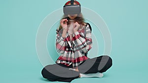Teenager child girl kid use virtual reality VR app headset helmet to play simulation 3D video game