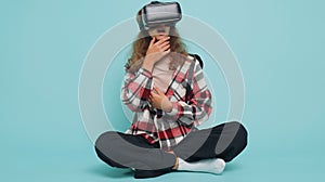 Teenager child girl kid use virtual reality VR app headset helmet to play simulation 3D video game