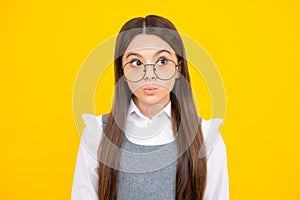 Teenager child girl with shocked facial expression. Surprised face expression,  on yellow background. Funny