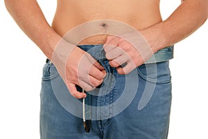 Teenager clasps fly on trousers photo