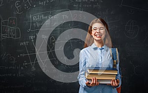 Teenager in class on background of blackboard