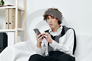 teenager on the couch with the phone internet living room