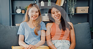 Teenager couple Asian women feeling happy smiling and looking to camera while relax in living room at home. Cheerful Roommate