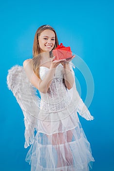 Teenager Cupid. Portrait of blond Angel girl present gift. Concept of innocent girl. Valentines day. Cupid cute girl