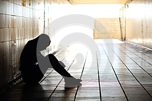 Teenager depressed sitting inside a dirty tunnel photo