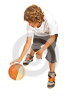 Teenager dribbling basketball photo
