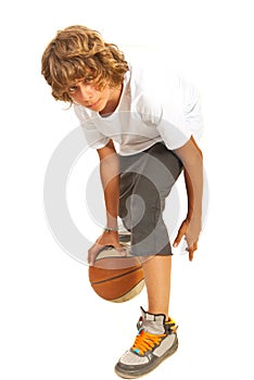 Teenager dribbling basketball photo