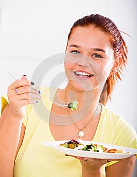 Teenager eating salad