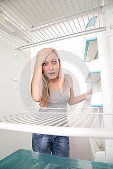 Teenager and empty fridge