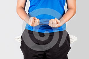 Teenager with empty pockets holding both fists