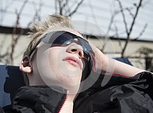 Teenager enjoying springs first sunbeams