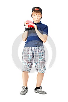 Teenager with expression of surprise on face holding skateboard in hands