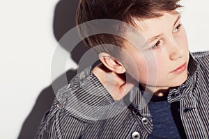 Teenager, fashion and boy thinking in studio, white background or dream of future. Cool, style and child with ideas