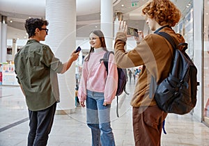 Teenager friends recording interview streaming live video from shopping mall