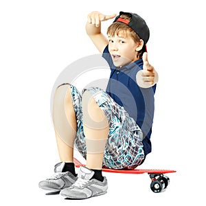 Teenager with funny expression face gesticulates with a hands, sitting on a skateboard
