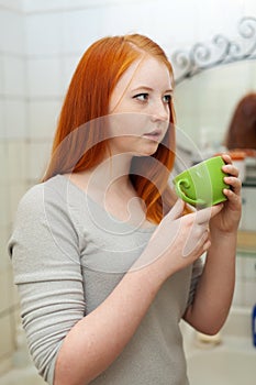 Teenager gargling throat in bathroom