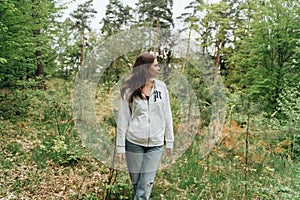 teenager gen z girl walking in the forest. close to nature concept