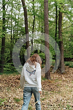 teenager gen z girl walking in the forest. close to nature concept