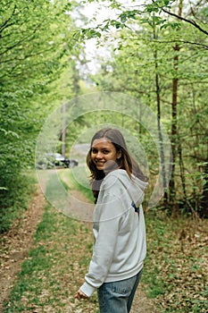 teenager gen z girl walking in the forest. close to nature concept