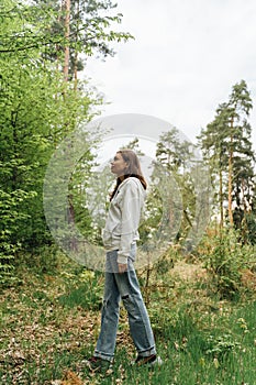 teenager gen z girl walking in the forest. close to nature concept