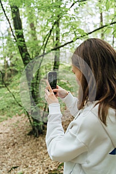 teenager gen z girl walking in the forest. close to nature concept