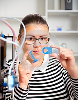 Teenager girl with 3d printe. education