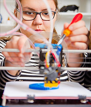 Teenager girl with 3d printe. education