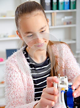 Teenager girl with 3d printe. education