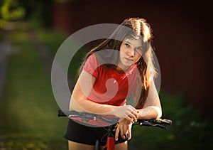 Teenager girl with bicycle country summer outdoor portrait